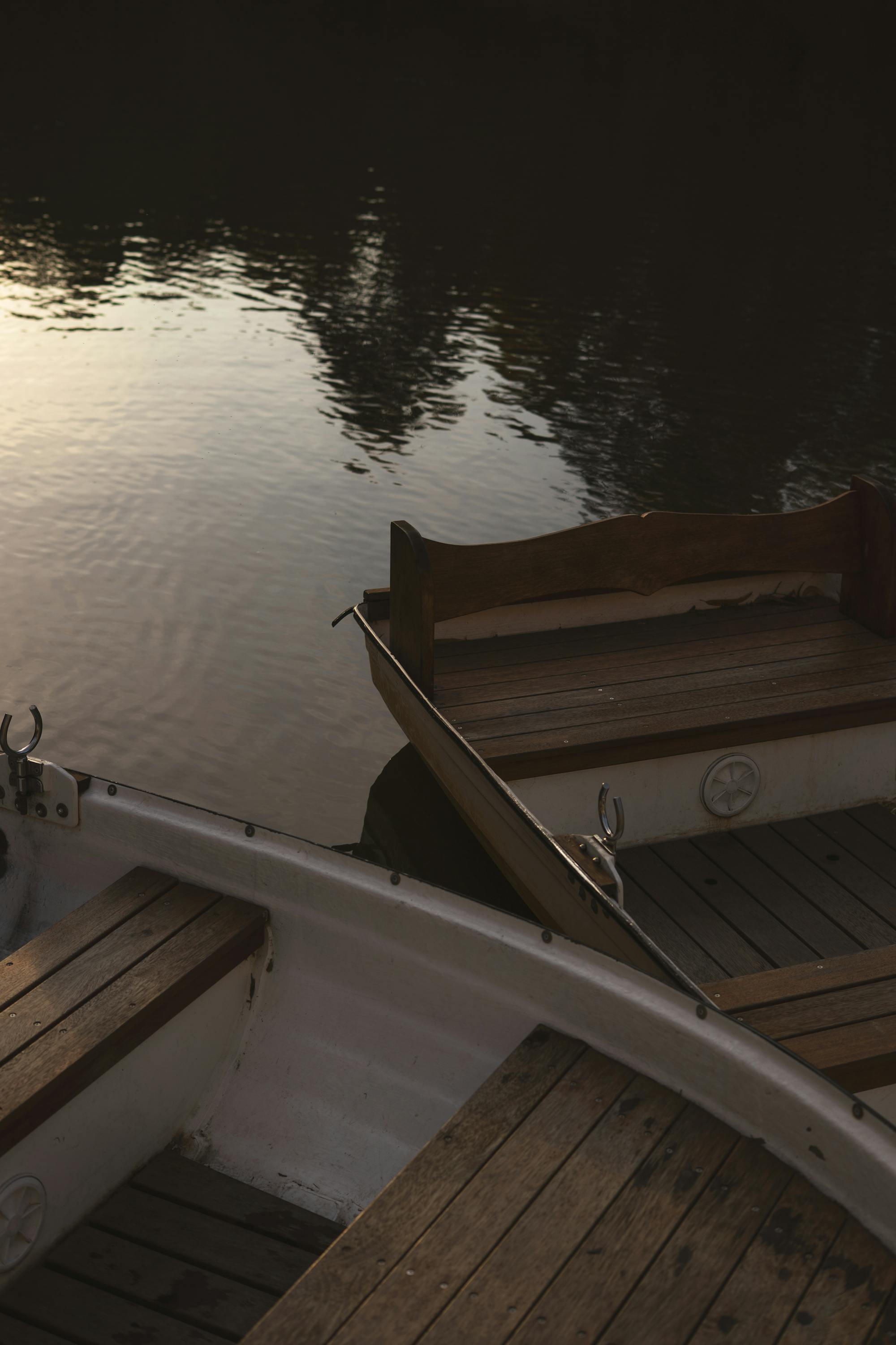 Détail bois sur barque amarrée au crépuscule, reflets dorés sur l’eau